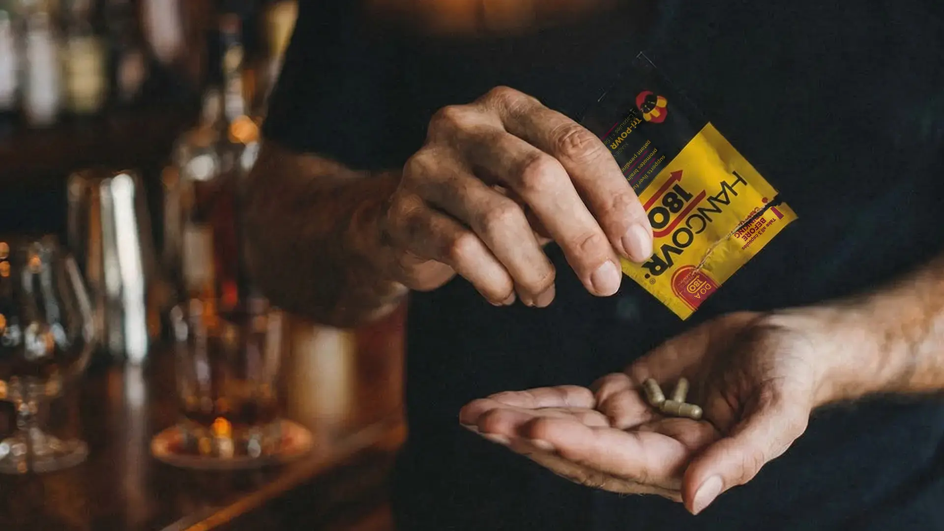 Man holding HANGOVR180® pouch at a bar