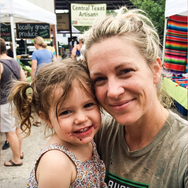 Sarah at farmers market with her child